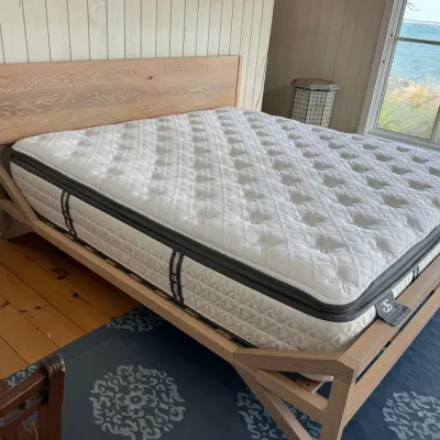 Sale Photo Thumbnail #19: Modern natural oak platform bed frame with a minimalist paneled headboard, fitted with a thick pillow-top mattress.