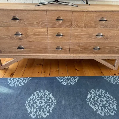 Sale Photo Thumbnail #18: Mid-century modern style light wood nine-drawer credenza featuring circular recessed drawer pulls and angular base legs.