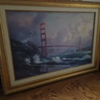 Sale Photo Thumbnail #68: Large framed Thomas Kinkade print depicting the Golden Gate Bridge, set in an ornate gilded frame with a double mat.