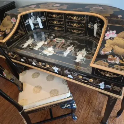 Sale Photo Thumbnail #20: Black lacquer writing desk with matching chair, decorated with hand-painted lotus flowers and mother-of-pearl figural inlays under a glass writing surface.