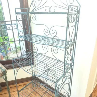 Sale Photo Thumbnail #91: Vintage teal wrought iron baker's rack featuring intricate scrollwork and four slatted metal shelves.