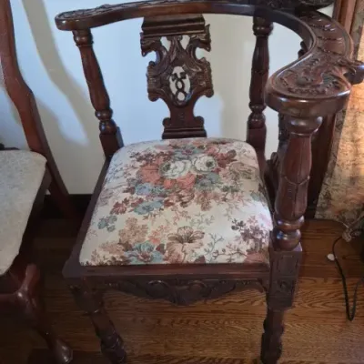 Sale Photo Thumbnail #97: Antique carved wood corner chair with floral tapestry upholstery, ornate back splats, and turned legs.