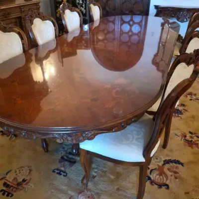 Sale Photo Thumbnail #5: Ornate Italian Baroque-style dining set featuring a high-gloss inlaid wood oval table and matching carved upholstered dining chairs.