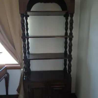 Sale Photo Thumbnail #37: Traditional dark wood open-shelf bookcase featuring turned-spindle supports, an arched top motif, and a lower two-door storage cabinet.