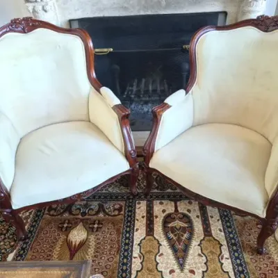 Sale Photo Thumbnail #23: Pair of French Provincial style upholstered armchairs featuring carved mahogany frames and off-white fabric.