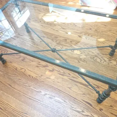 Sale Photo Thumbnail #90: Rectangular coffee table with a clear glass insert and a green-patinated metal frame featuring an X-brace stretcher.
