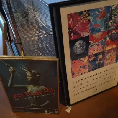 Sale Photo Thumbnail #180: Pair of framed exhibition posters, including an "Art.Rage.Us." breast cancer awareness poster and a 1997 "Stewardship in the New Millennium" San Francisco event poster.