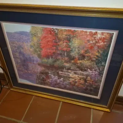Sale Photo Thumbnail #65: Large framed autumn landscape print featuring vivid fall foliage along a reflective lake, set within a double mat and ornate gold frame.