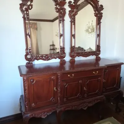 Sale Photo Thumbnail #33: Ornate mahogany sideboard in Chippendale style featuring carved shell accents, cabriole legs with ball-and-claw feet, and two matching elaborate wall mirrors.