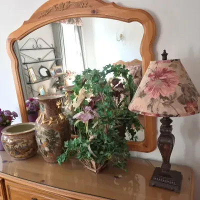 Sale Photo Thumbnail #51: Pine dresser topped with an arched mirror, featuring a floral lampshade, decorative Satsuma-style porcelain vases, and faux greenery.