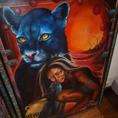 Sale Photo Thumbnail #76: Framed canvas painting featuring a fantasy scene of a crouching woman with a pouring vessel alongside a large blue black panther, presented in an ornate decorative frame.