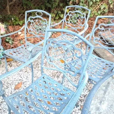 Sale Photo Thumbnail #173: Set of four light blue cast aluminum patio chairs with decorative backs and diamond-pattern seats.
