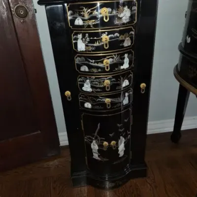 Sale Photo Thumbnail #36: Black lacquer standing jewelry armoire featuring mother-of-pearl figural inlays, painted gold accenting, and brass hardware.