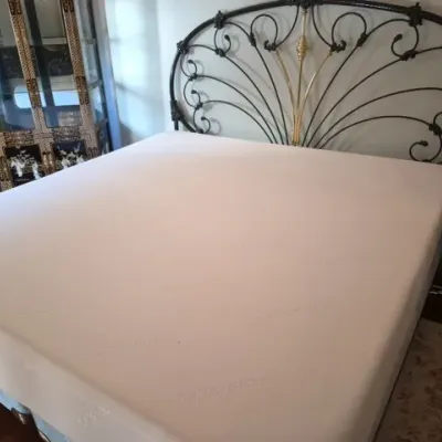 Sale Photo Thumbnail #45: Tuft & Needle mattress set framed by an ornate black wrought iron headboard with gold accents.