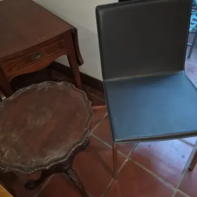 Sale Photo Thumbnail #99: Collection of small furniture pieces, including a modern black leather dining chair with chrome legs, a mahogany piecrust tilt-top accent table, and a mahogany drop-leaf end table.