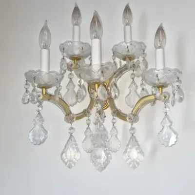 Sale Photo Thumbnail #85: Vintage crystal wall sconce fixture featuring five candelabra lights, scalloped bobeches, and dangling faceted prism drops.