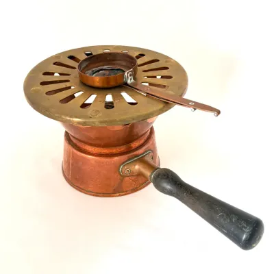 Vintage copper and brass chafing dish burner with turned dark wood handle and burner cap, showing light aged patina.