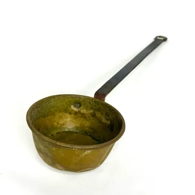 Antique rustic brass ladle or water dipper featuring a long wrought iron handle attached with rivets.