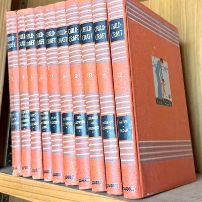 Vintage Child-Craft book set published by Quarrie, featuring orange cloth covers with silver-tone decorative striping and black title...