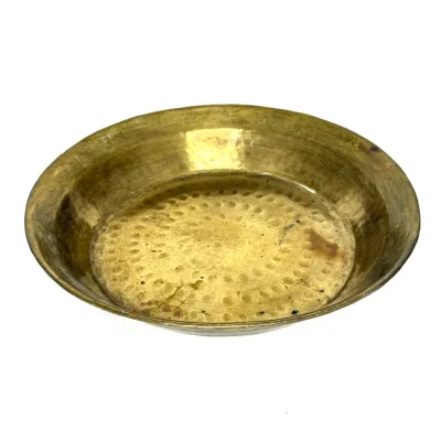 Hand-hammered brass dish with a concentric textured pattern and aged patina.