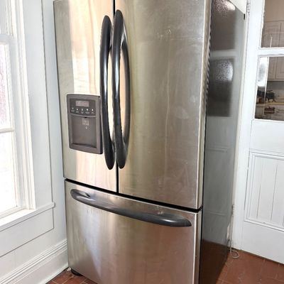 Kenmore stainless steel French door refrigerator with a bottom freezer drawer and in-door ice and water dispenser.