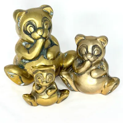 Set of three vintage solid brass panda bear figurines in graduated sizes with a natural aged patina.