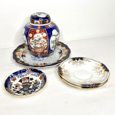 Collection of vintage Imari style porcelain pieces, including a ginger jar with lid, matching serving platter, small dish, and gilded...