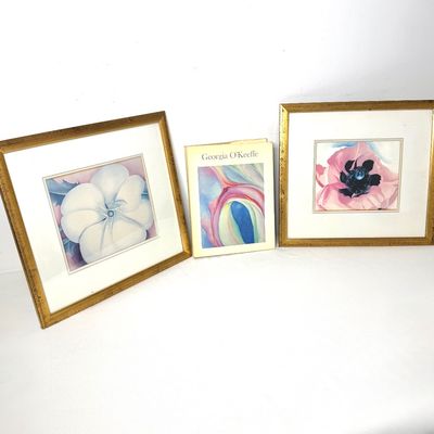 Pair of framed Georgia O'Keeffe floral art prints in gold frames, displayed alongside a Georgia O'Keeffe art book.