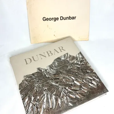 George Dunbar art monograph exhibition catalog with metallic textured cover design, displayed with its matching slipcase.