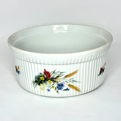 Vintage white porcelain bowl featuring ribbed sides and a colorful floral bouquet motif.