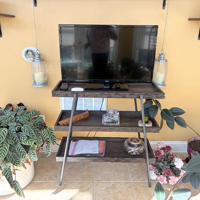 Sale Photo Thumbnail #121: Modern Seiki flat-screen television on a three-tiered dark wood media stand with A-frame metal legs.