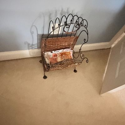 Sale Photo Thumbnail #274: Wrought iron and woven wicker magazine rack featuring scrolled wire accents and a arched handle design.