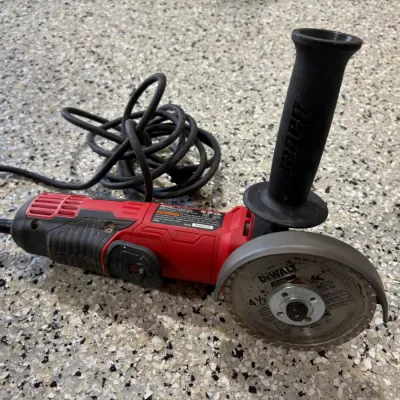 Sale Photo Thumbnail #66: Bauer corded angle grinder fitted with a DeWalt 4.5-inch masonry cutting wheel and side handle.