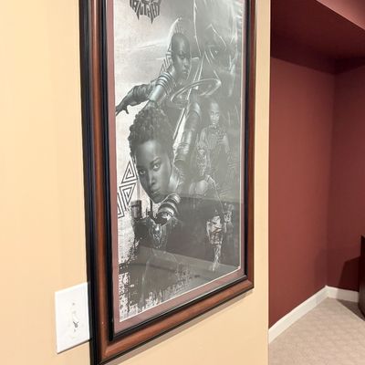 Sale Photo Thumbnail #219: Framed monochrome Black Panther movie poster housed in a dark wooden frame with double matting.