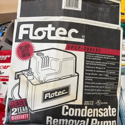 Sale Photo Thumbnail #19: Vintage Flotec condensate removal pump model FPCP-20ULST in its original cardboard box, showing wear and discoloration.