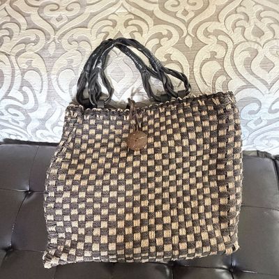 Sale Photo Thumbnail #300: Handwoven basketweave tote bag in brown and beige featuring braided leather handles and a loop closure with a wooden button detail.