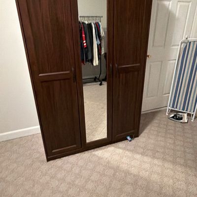 Sale Photo Thumbnail #226: Modern dark brown wood three-door wardrobe armoire featuring a full-length mirrored center door panel.
