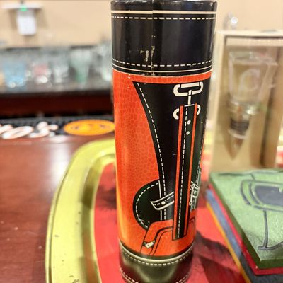 Sale Photo Thumbnail #167: Vintage golf bag-themed novelty cocktail shaker container or barware tube in red, black, and white.