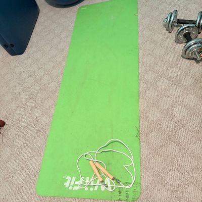 Sale Photo Thumbnail #261: Bright green WiiFit exercise mat with a jump rope, alongside chrome adjustable dumbbells and an aerobic step in the background.