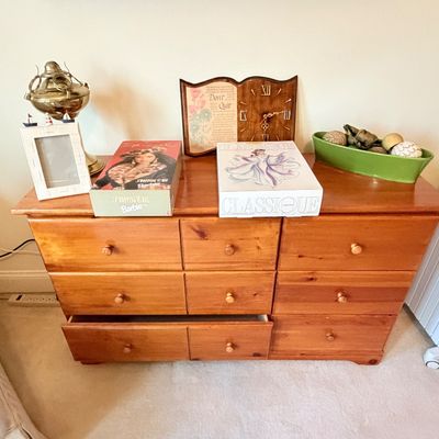 Sale Photo Thumbnail #293: Pine wood six-drawer dresser displaying decorative tabletop accessories and collectible boxed Barbie dolls.