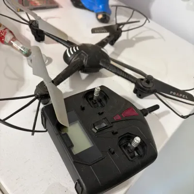 Sale Photo Thumbnail #21: Black Propel brand remote control quadcopter drone with its matching controller.