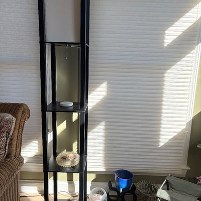 Sale Photo Thumbnail #149: Modern black wooden shelf floor lamp featuring integrated display tiers and a tall fabric lampshade.