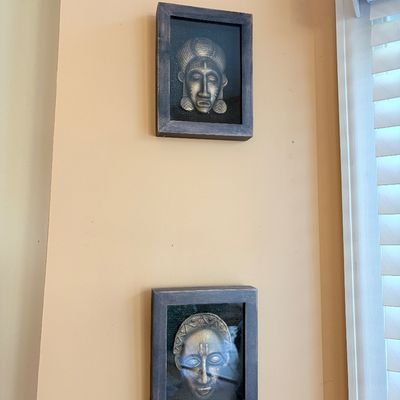 Sale Photo Thumbnail #152: Pair of framed shadowbox wall art pieces featuring metallic African-style mask reliefs set against dark fabric backgrounds.