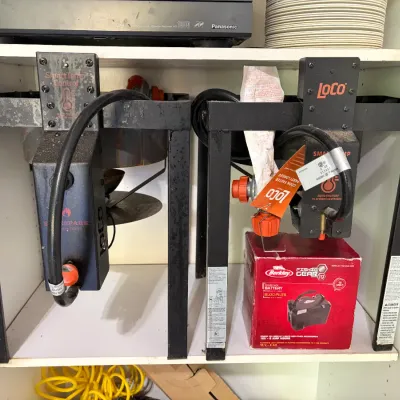 Sale Photo Thumbnail #46: Two LoCo SmartTemp propane outdoor burners housed in black metal frames, accompanied by a boxed Berkley Fishin' Gear power pack battery.