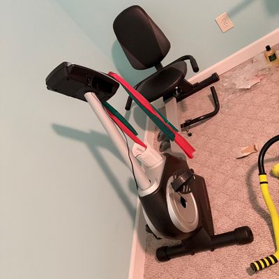 Sale Photo Thumbnail #258: Weslo recumbent exercise bike featuring a digital display console, adjustable padded seat, and integrated resistance bands.