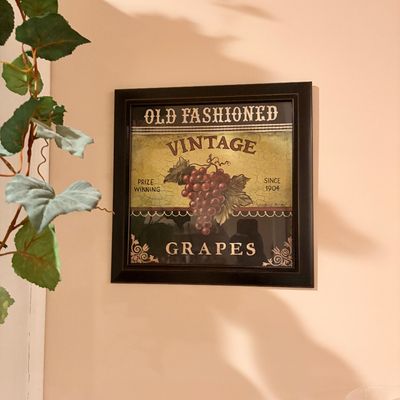 Sale Photo Thumbnail #185: Framed vintage-style sign featuring grape artwork and typography, housed in a dark wooden frame.