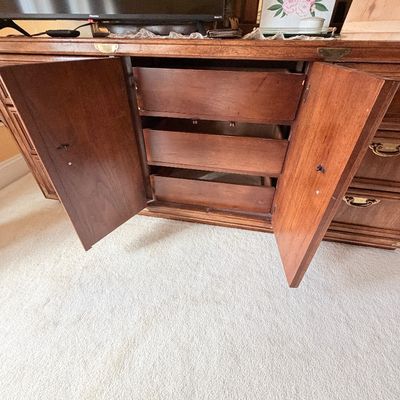 Sale Photo Thumbnail #280: Traditional wooden credenza or dresser with open center cabinet doors revealing pull-out interior drawers.