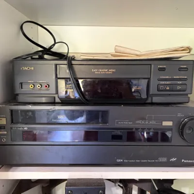 Sale Photo Thumbnail #47: Stack of vintage VCR decks, including an Hitachi VCR and a Panasonic AG-1950 ProLine multi-function video cassette recorder.