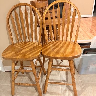 Sale Photo Thumbnail #253: Set of light oak swivel bar stools featuring arrow-back spindles and turned legs.