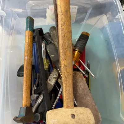Sale Photo Thumbnail #15: Clear plastic tote filled with assorted hand tools, including a wooden mallet, small hammer, screwdrivers, and scrapers.